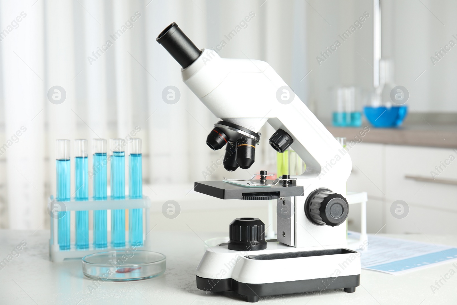 Photo of Modern microscope on white table in laboratory. Medical object