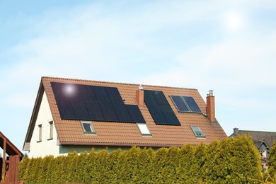 Photo of House with installed solar panels on roof, space for text. Alternative energy