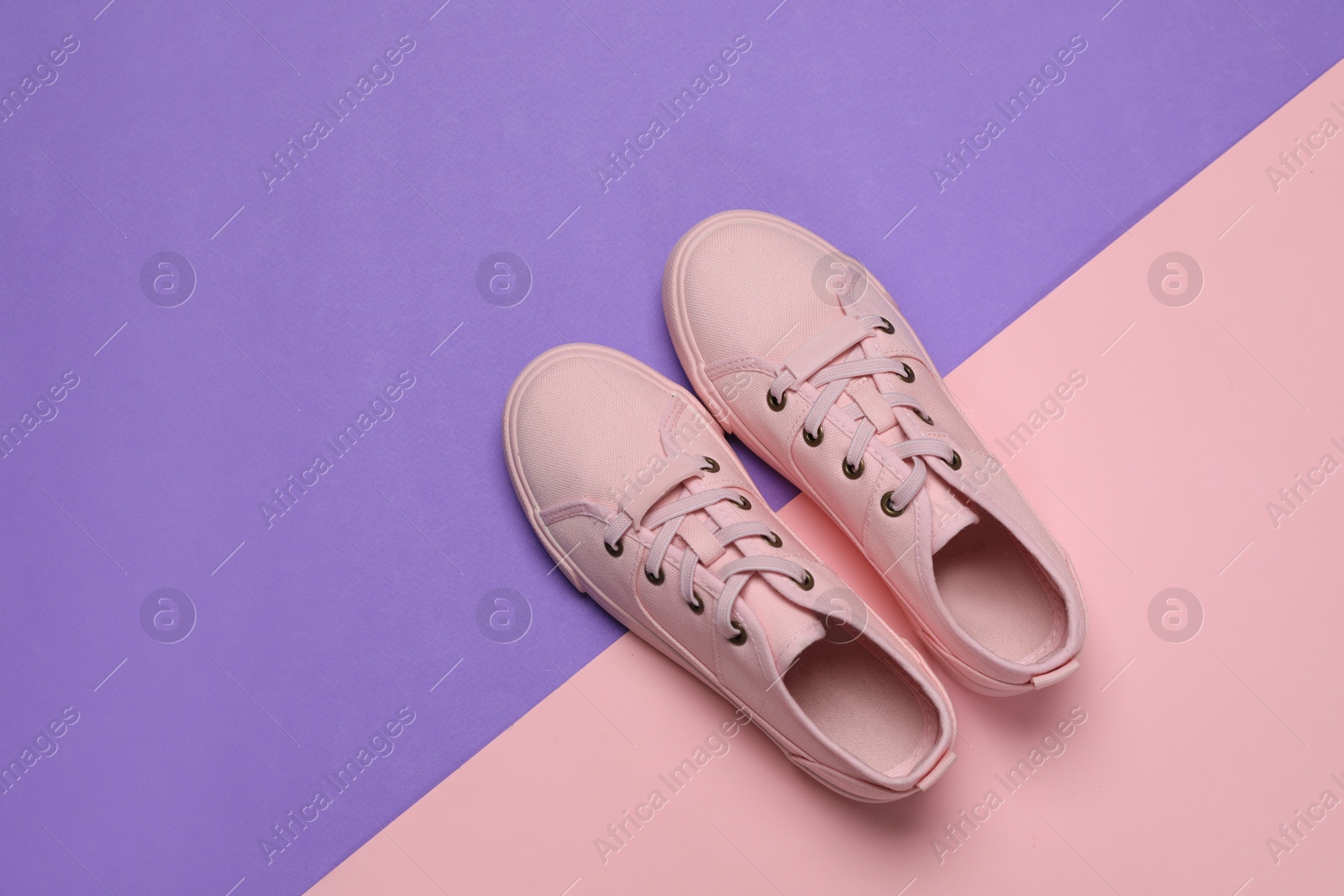 Photo of Pair of comfortable sports shoes on color background, flat lay. Space for text