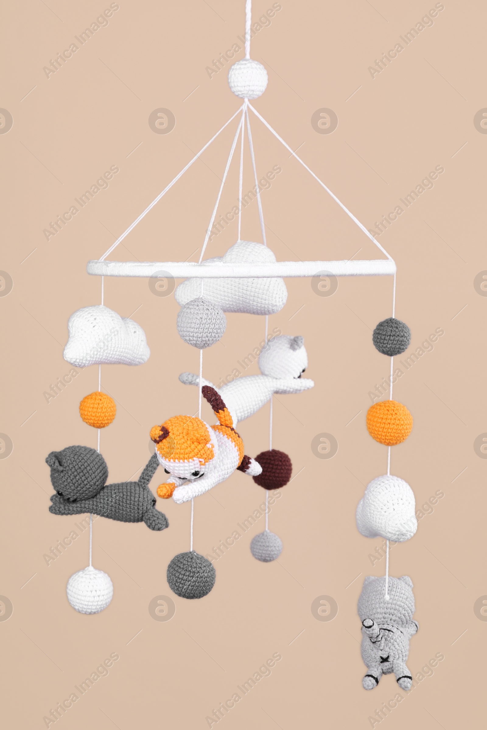 Photo of Cute baby crib mobile on beige background