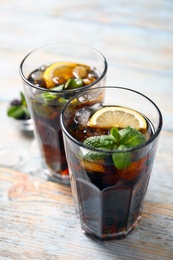 Glasses of fresh lemonade on wooden table