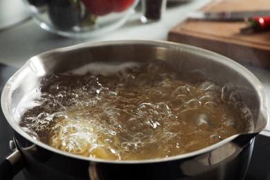 Photo of Cooking pasta in pot on stove, closeup
