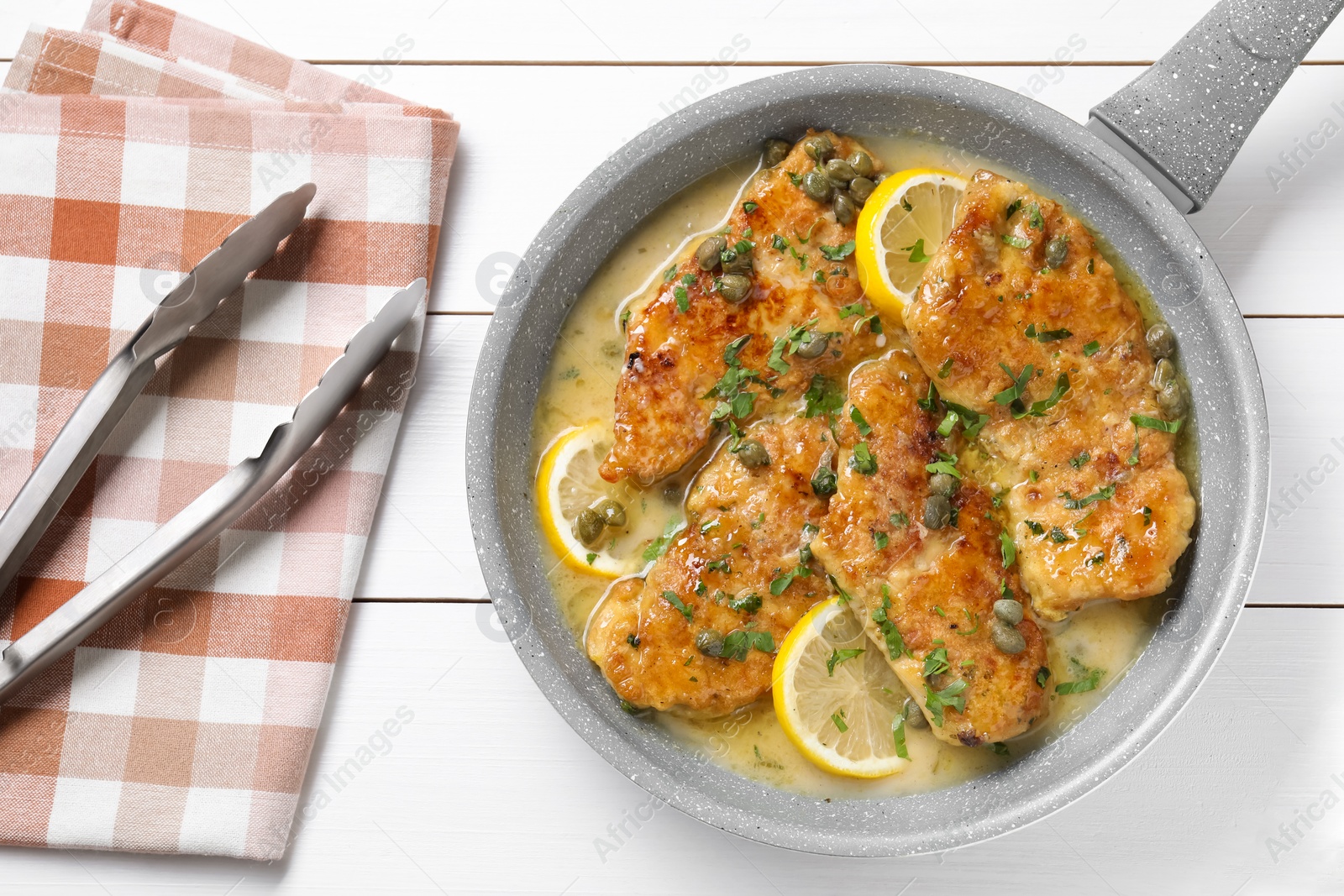 Photo of Delicious chicken piccata on white wooden table, top view