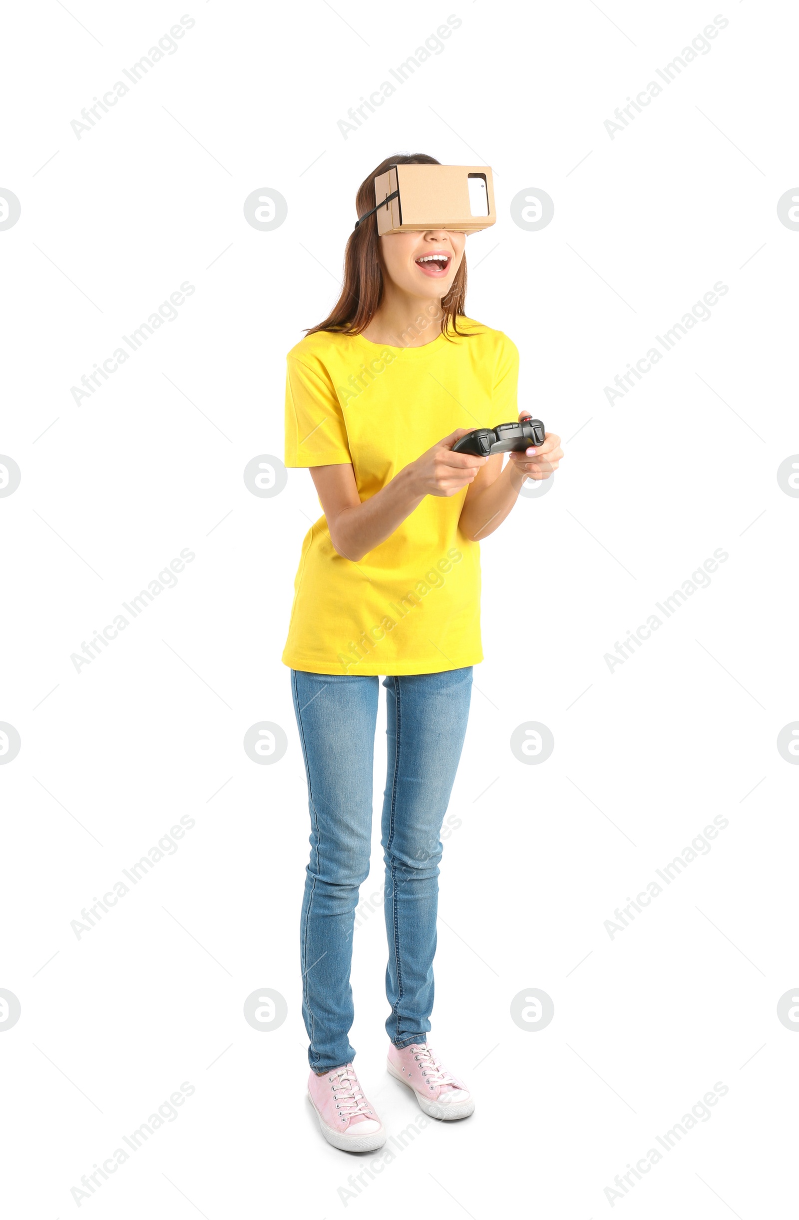 Photo of Young woman using cardboard virtual reality headset, isolated on white