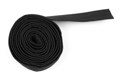 Photo of Black karate belt isolated on white, top view. Martial arts uniform