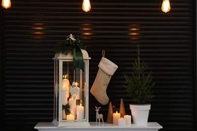 Decorative lantern and Christmas decor on shelf indoors