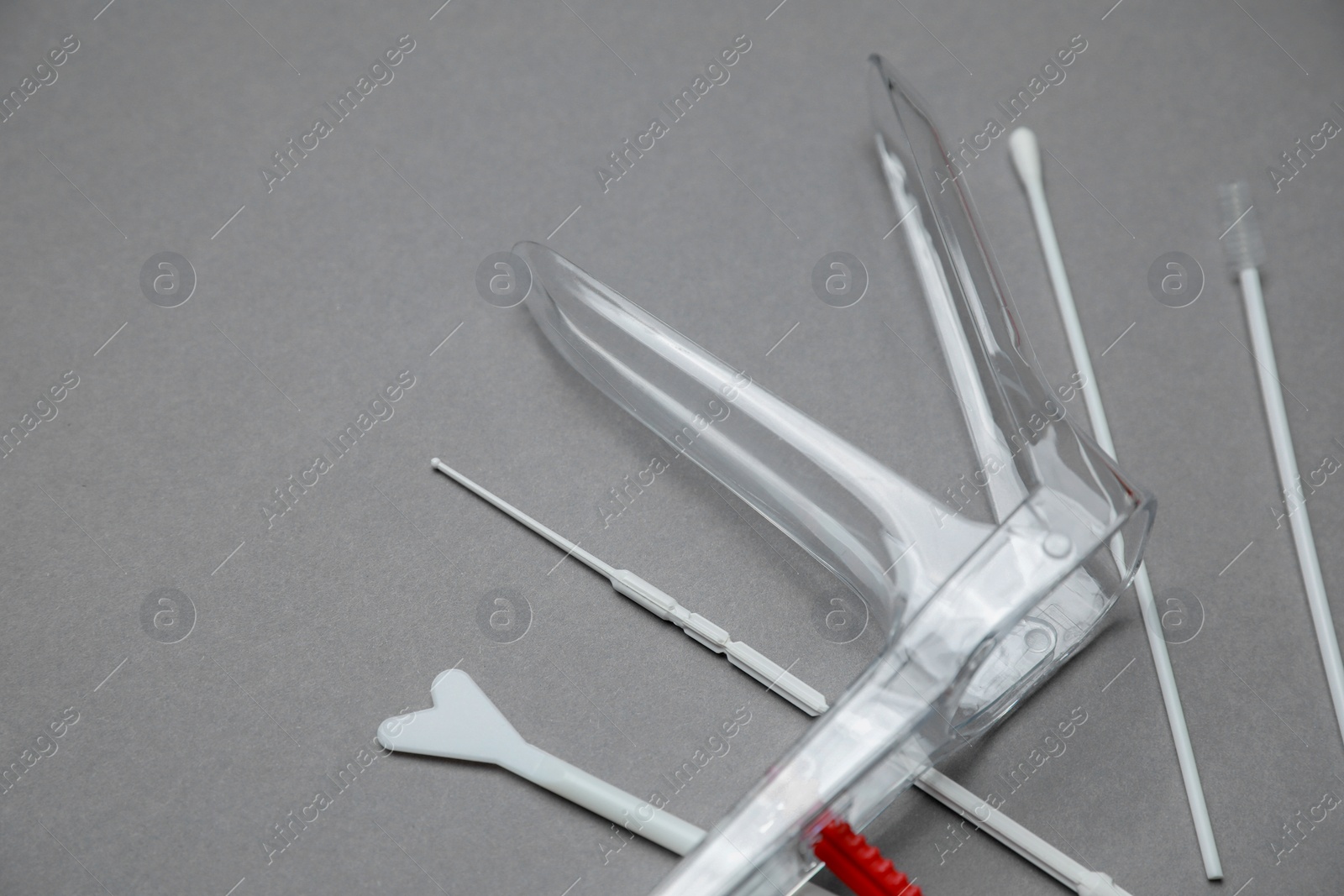 Photo of Sterile gynecological examination kit on grey background, space for text
