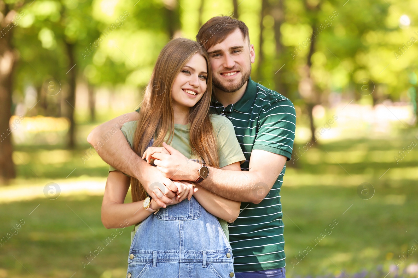 Photo of Happy young couple in green park on sunny spring day