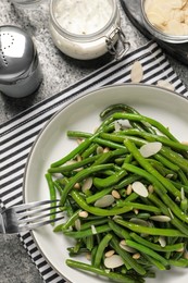 Tasty salad with green beans served on grey table, flat lay