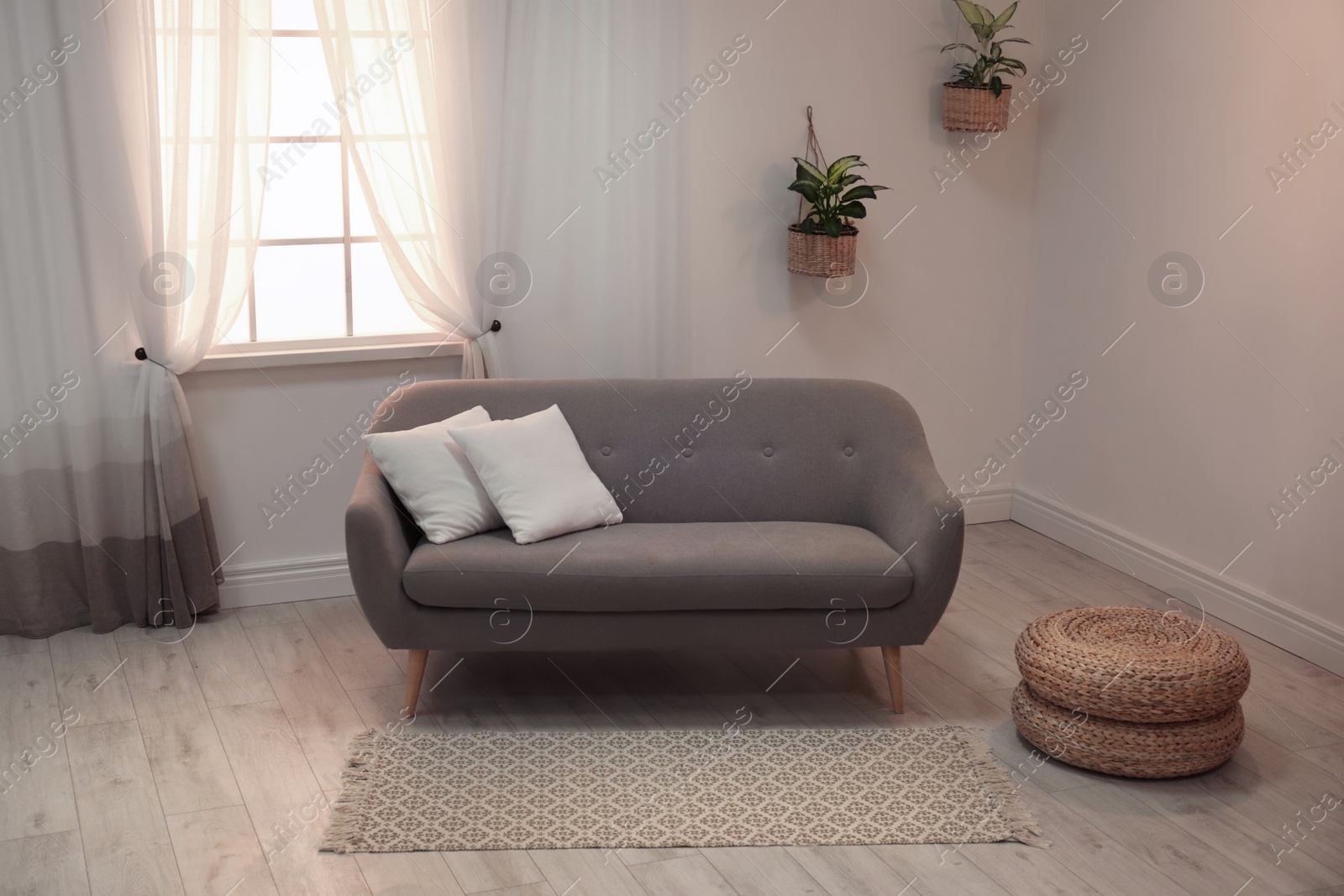 Photo of Modern comfortable sofa in stylish home interior