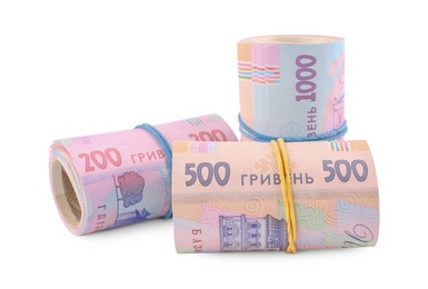 Rolls of Ukrainian money on white background