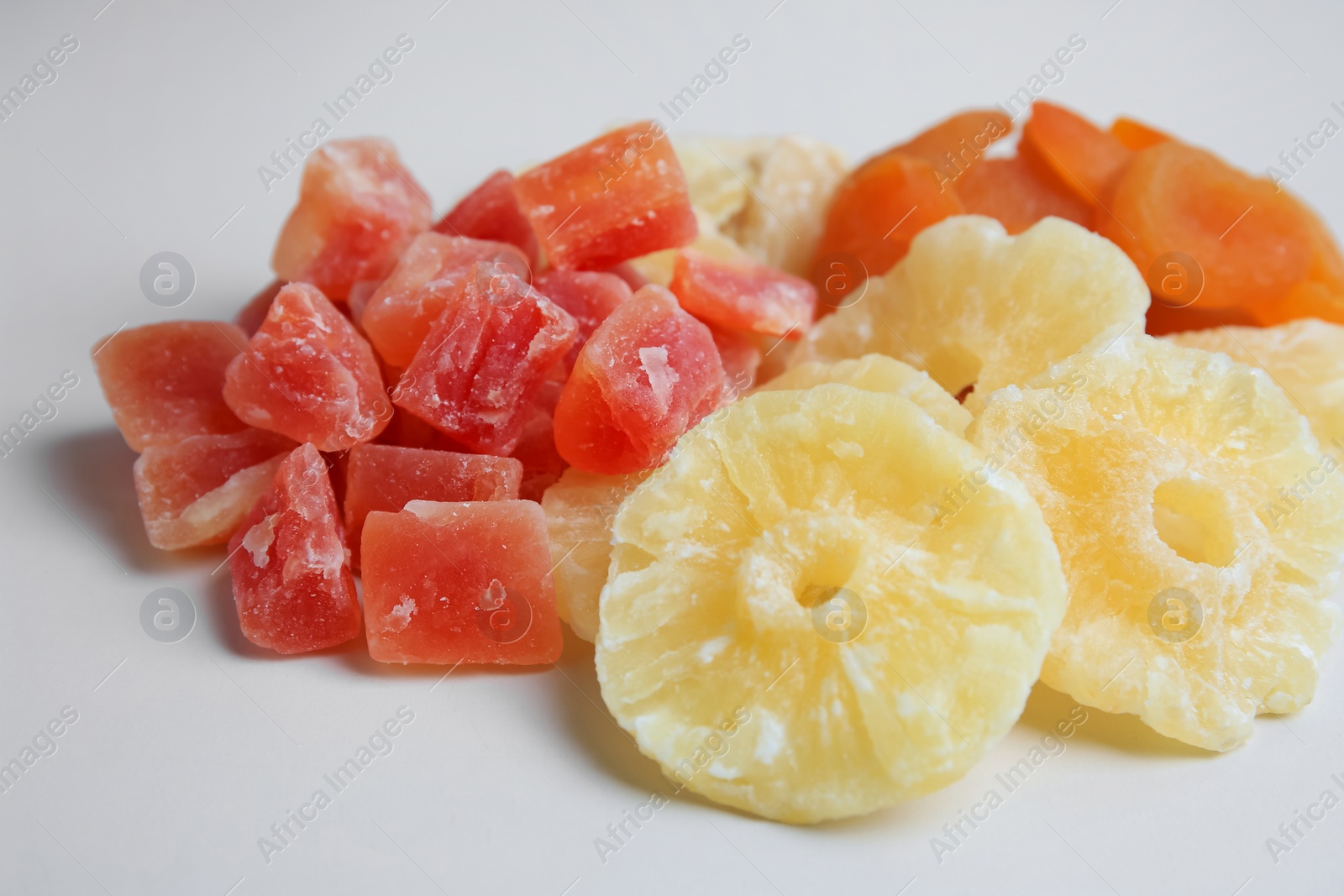 Photo of Pile of different dried fruits on white background, closeup