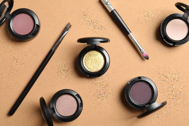 Photo of Flat lay composition with different eye shadows on color background