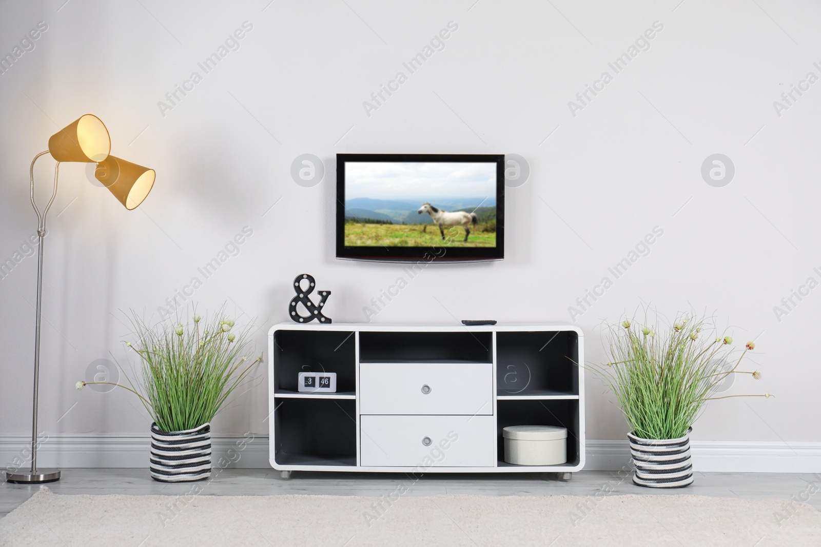 Image of Living room interior with TV set on light wall