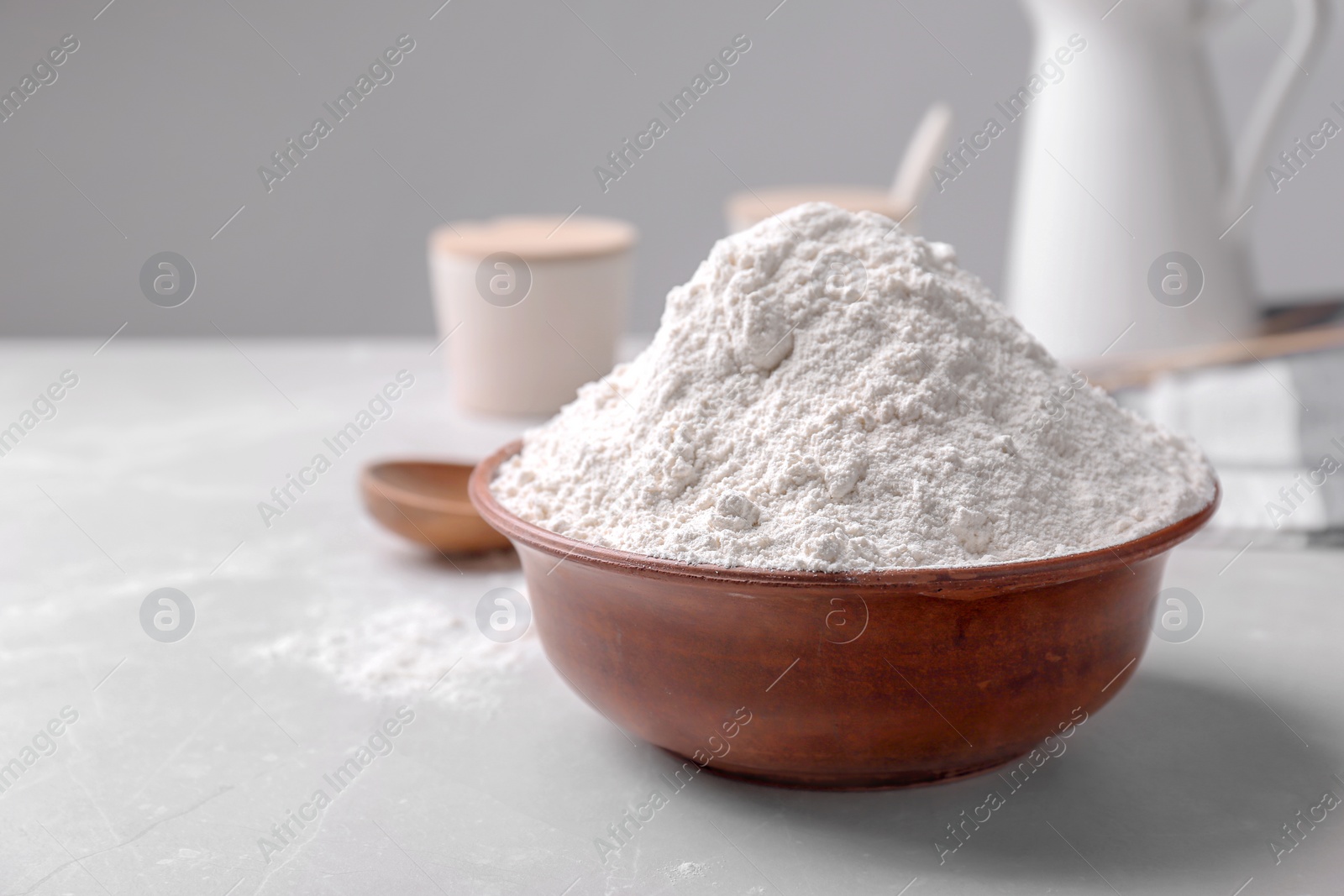 Photo of Wooden bowl with flour on table