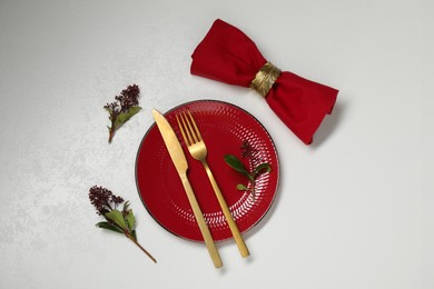 Stylish setting with elegant cutlery on white table, flat lay