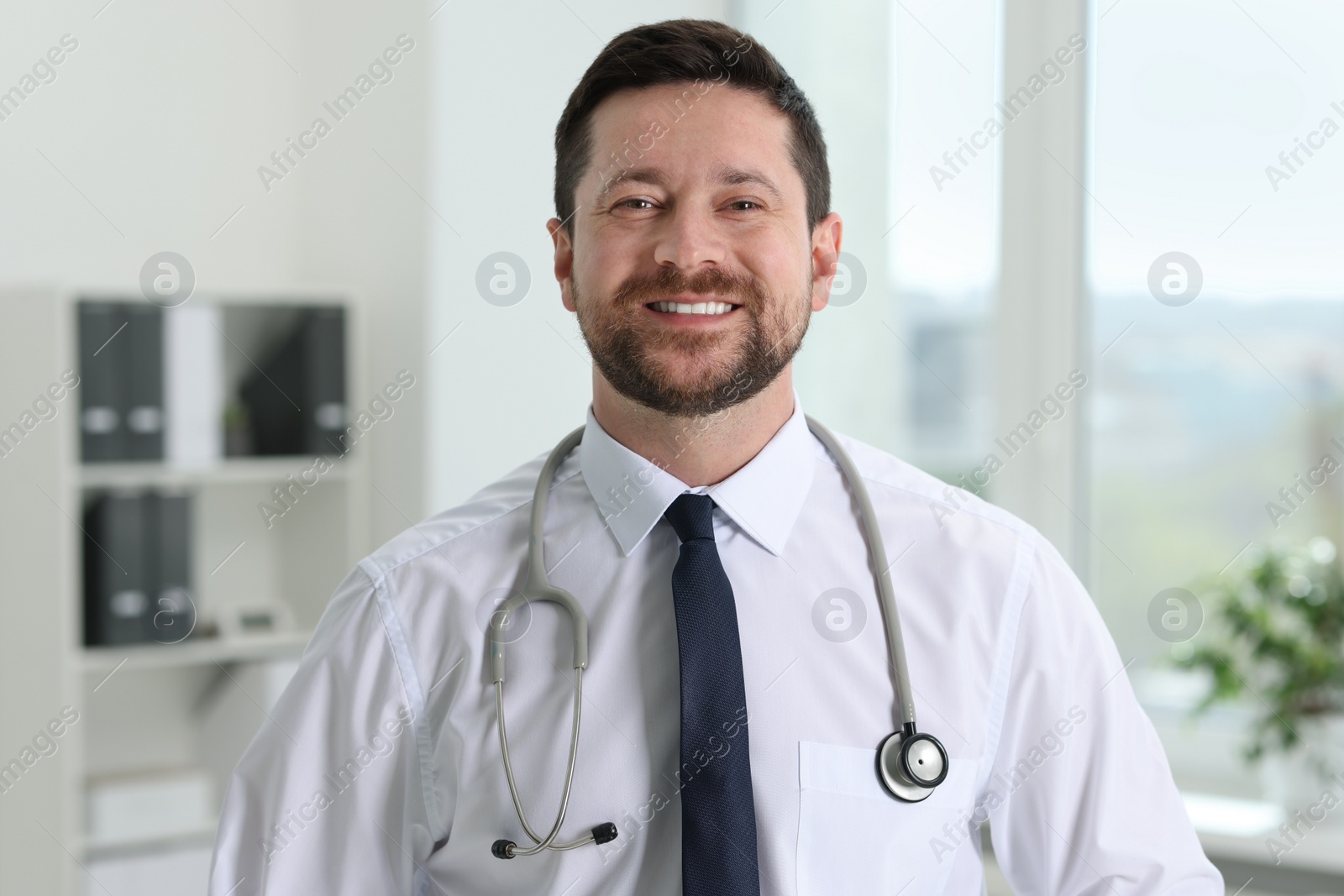 Photo of Portrait of smiling doctor with stethoscope in hospital