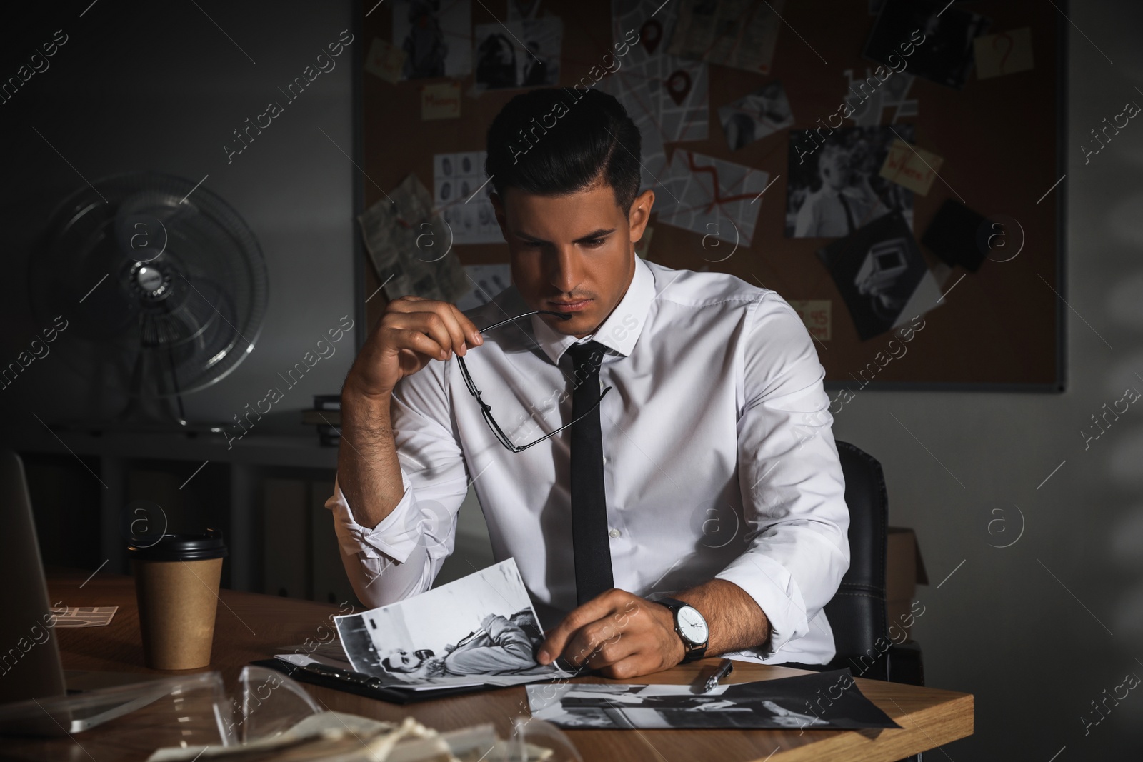 Photo of Detective working at desk in his office