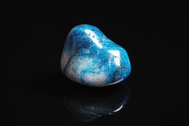 Photo of Beautiful blue shattuckite gemstone on black background