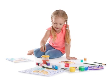 Photo of Cute child painting picture on white background