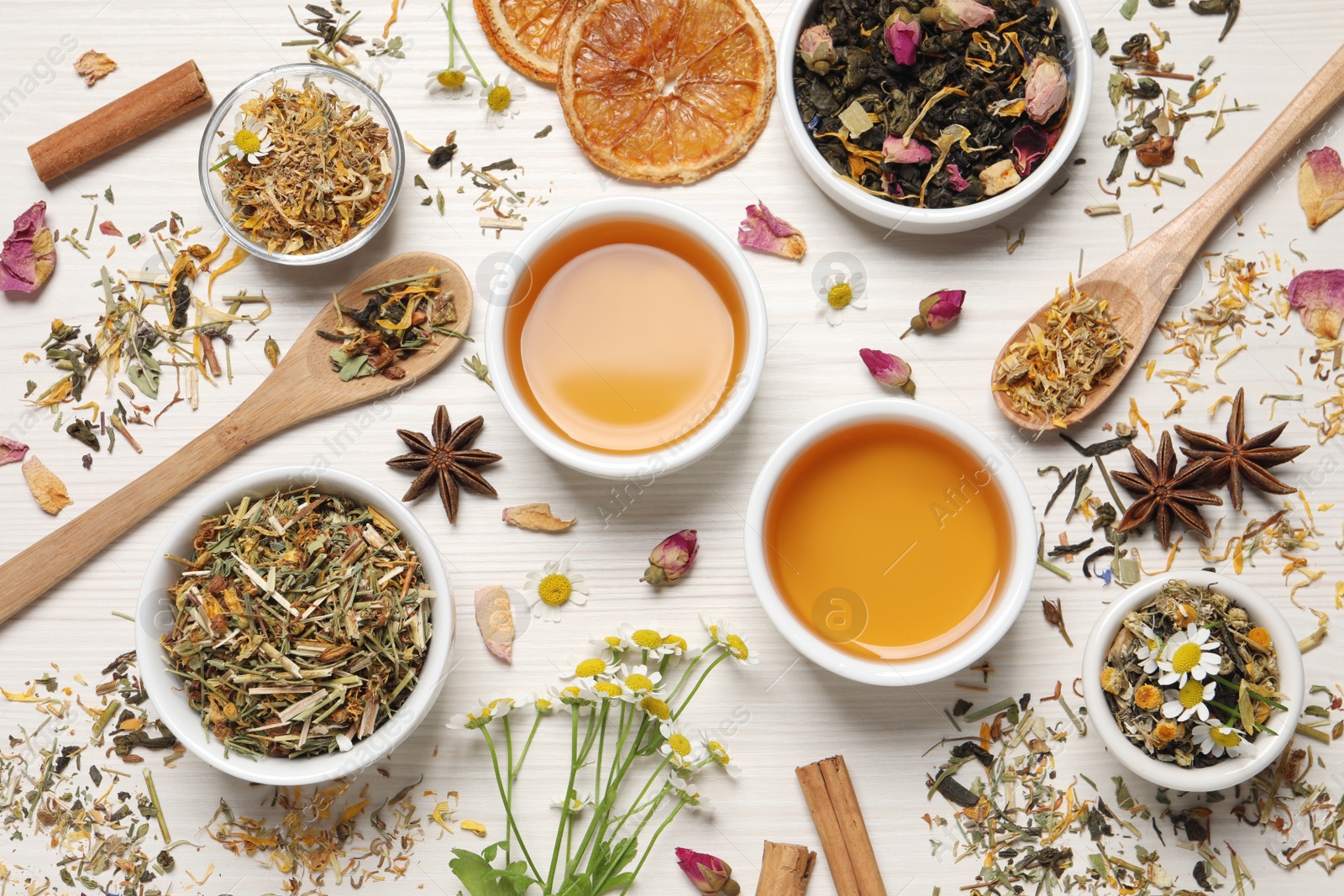 Photo of Flat lay composition with fresh brewed tea and dry leaves on white wooden table