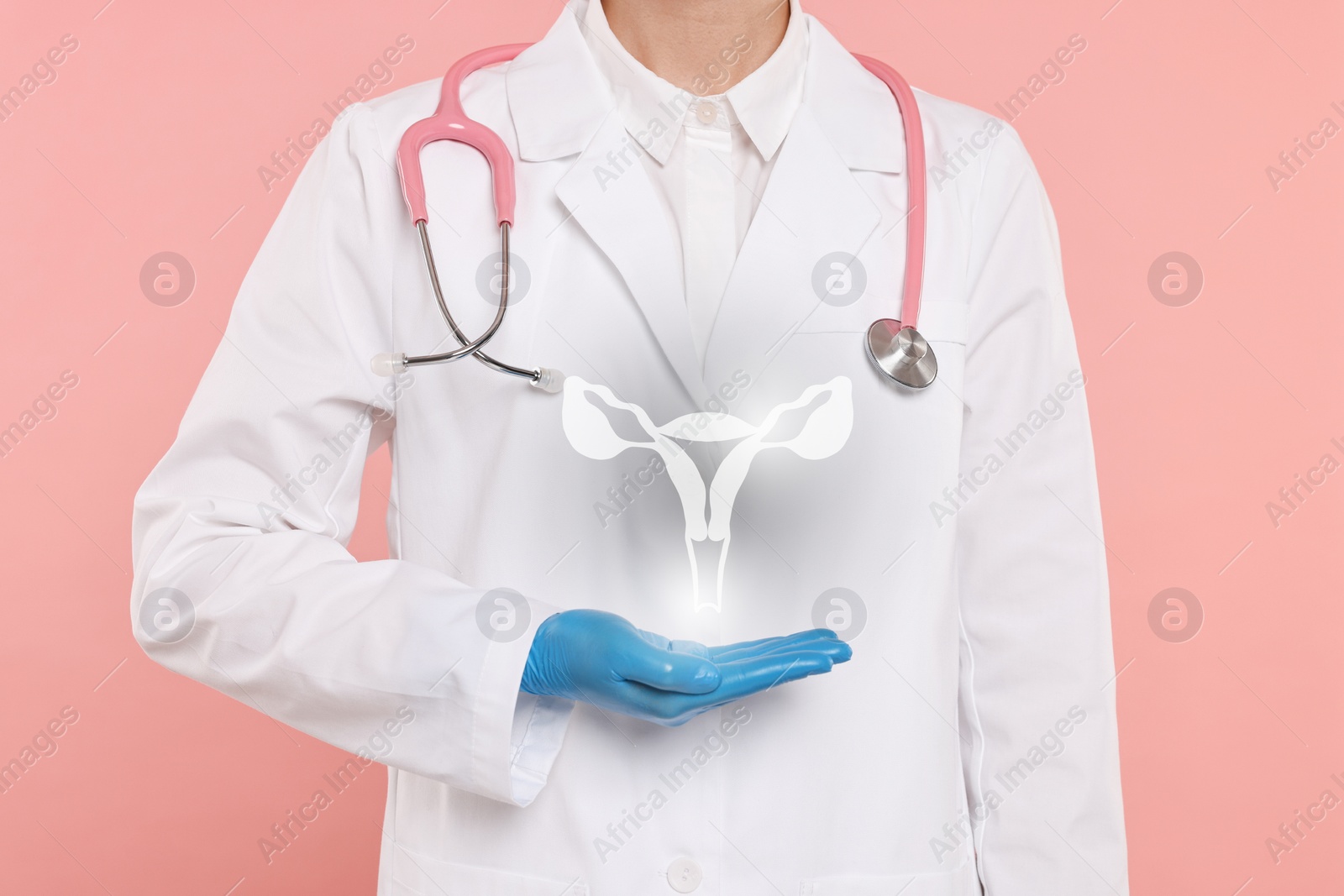 Image of Doctor and illustration of female reproductive system on pink background, closeup