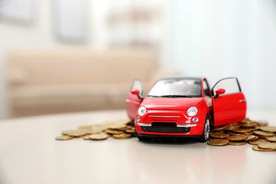 Photo of Miniature automobile model and money on table indoors, space for text. Car buying