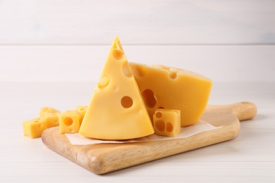 Photo of Tasty fresh cheese on white wooden table