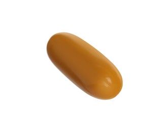 One light brown pill on white background. Medicinal treatment