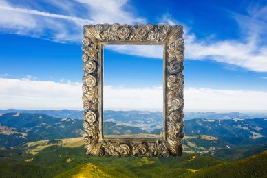 Image of Vintage frame and beautiful mountains under blue sky with clouds