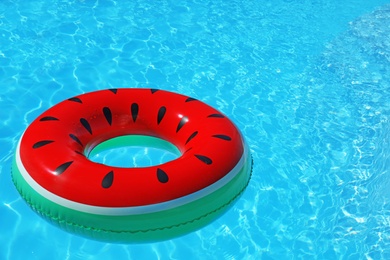 Photo of Inflatable ring floating in swimming pool on sunny day