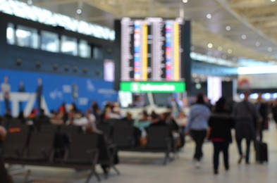 Photo of Blurred view of crowded airport waiting area