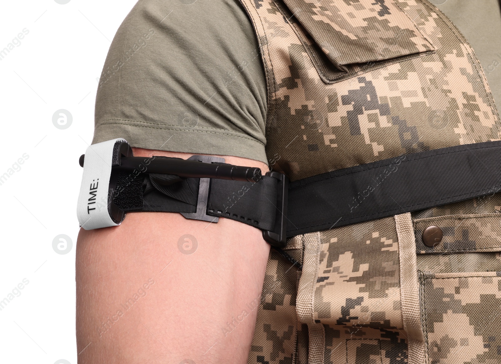 Photo of Soldier in military uniform applying medical tourniquet on arm against white background, closeup