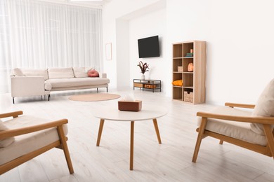 Photo of Comfortable furniture and sofa in room. Interior design