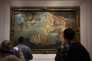 Florence, Italy - February 8, 2024: Visitors admiring painting "Birth of Venus" by Sandro Botticelli at Uffizi gallery