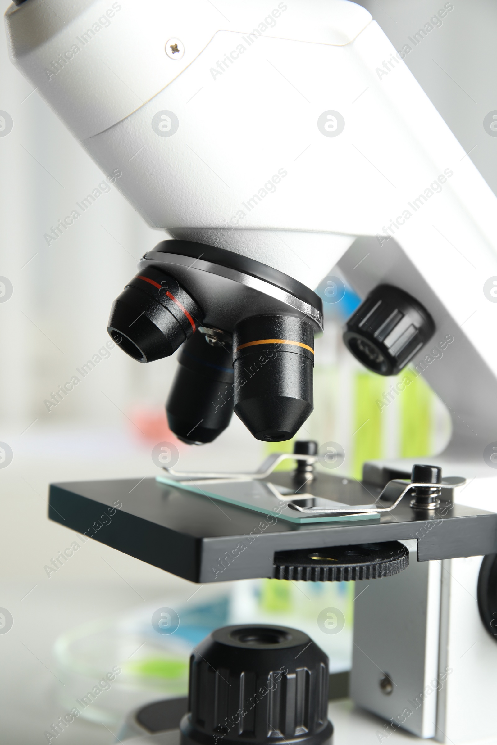 Photo of Modern microscope with different lenses in laboratory, closeup. Medical equipment