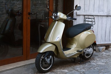 Photo of Beautiful scooter parked near building entrance outdoors