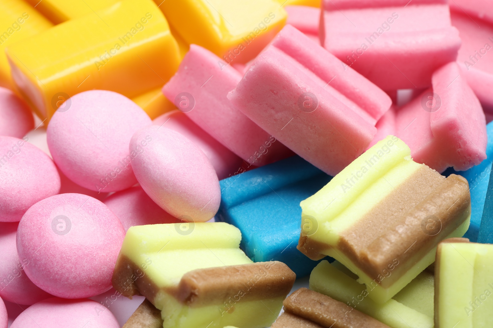 Photo of Different tasty colorful bubble gums as background, closeup