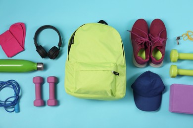 Photo of Different sports equipment on light blue background, flat lay