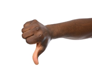 African-American man showing thumb down gesture on white background, closeup