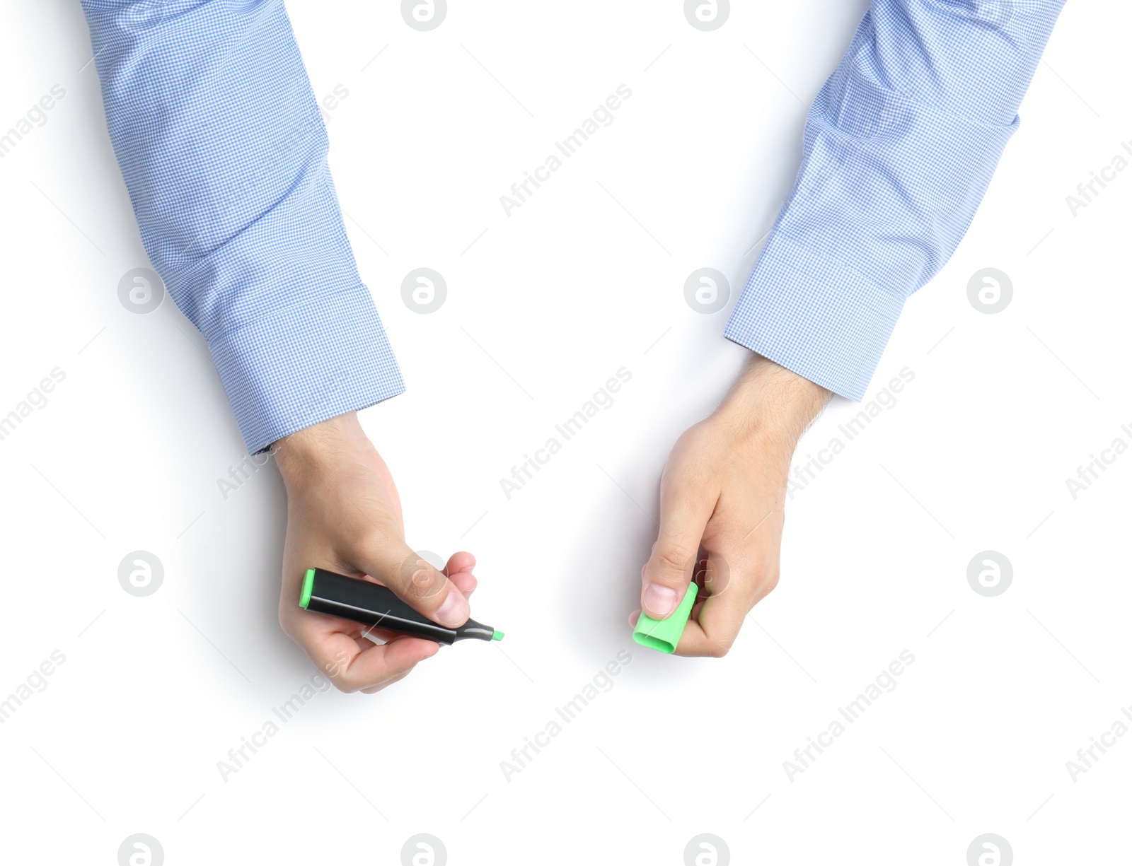 Photo of Man with highlighter on white background, top view. Closeup of hands