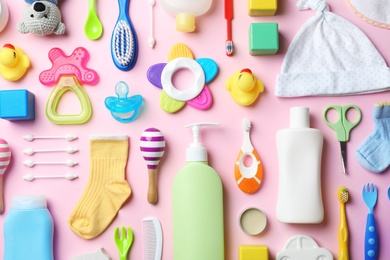 Flat lay composition with baby accessories and toys on color background