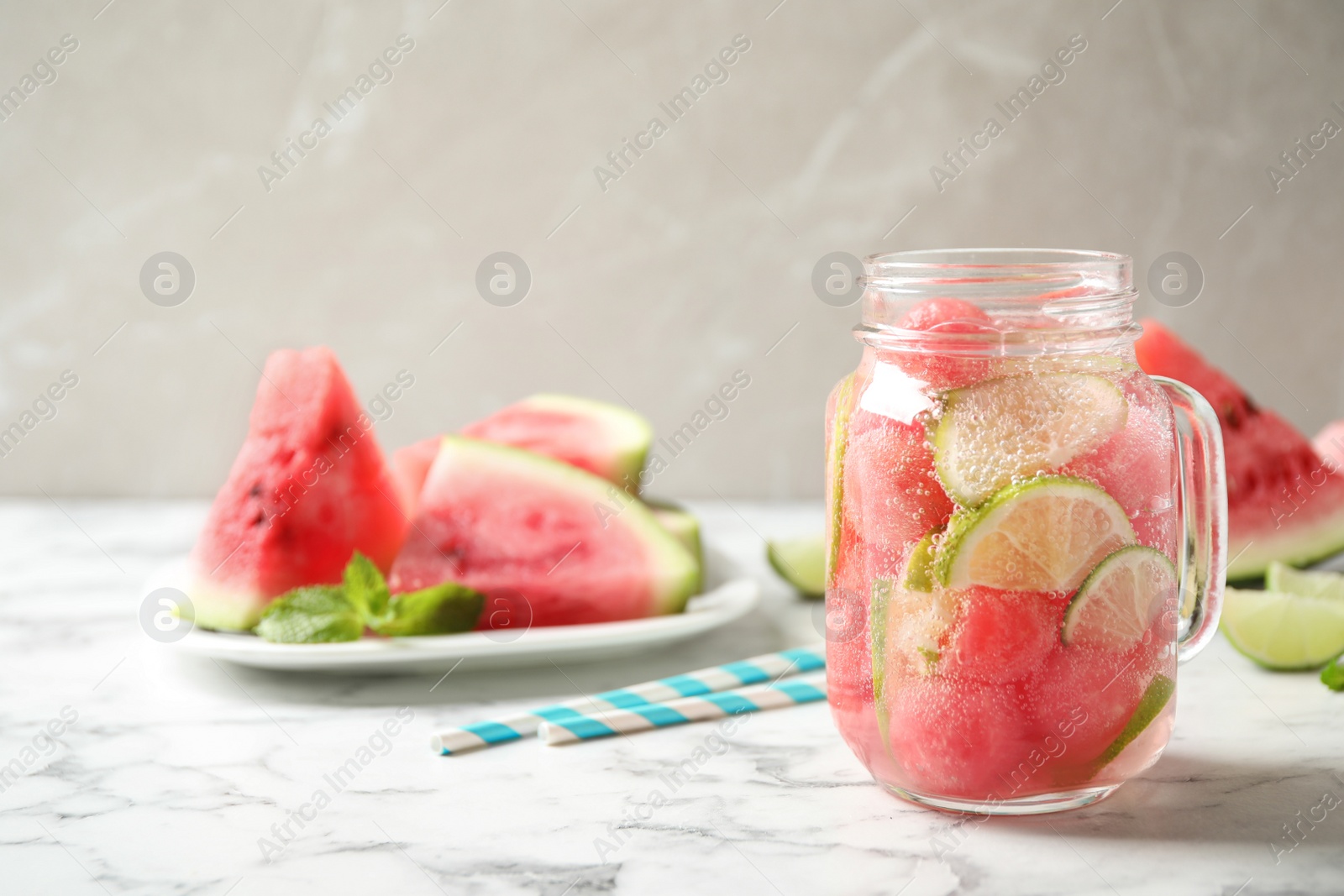 Photo of Tasty refreshing watermelon drink on marble table. Space for text