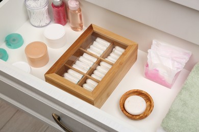 Photo of Storage of tampons and different hygiene products in white drawer