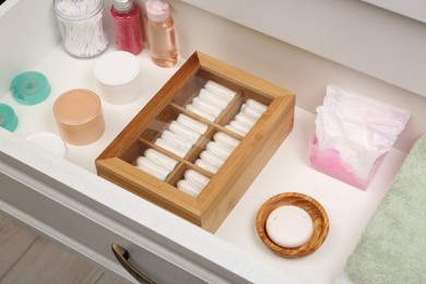 Storage of tampons and different hygiene products in white drawer