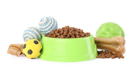 Photo of Various pet toys and bowl of food on white background