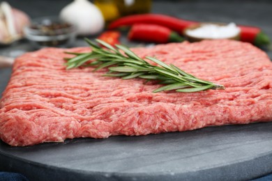 Photo of Raw fresh minced meat with rosemary, closeup