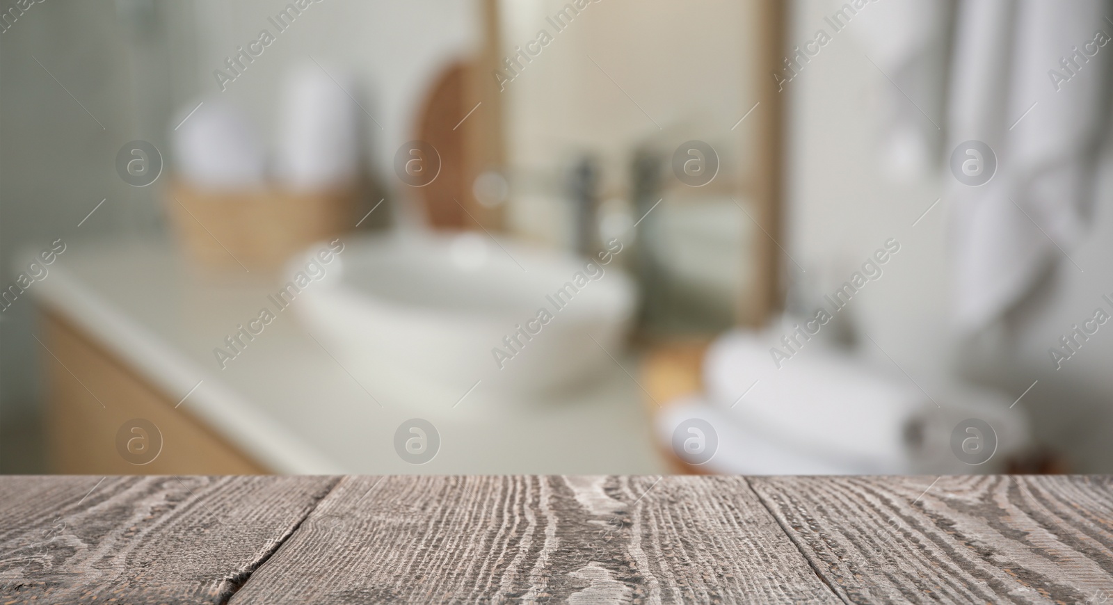 Image of Empty wooden table and blurred view of stylish bathroom interior