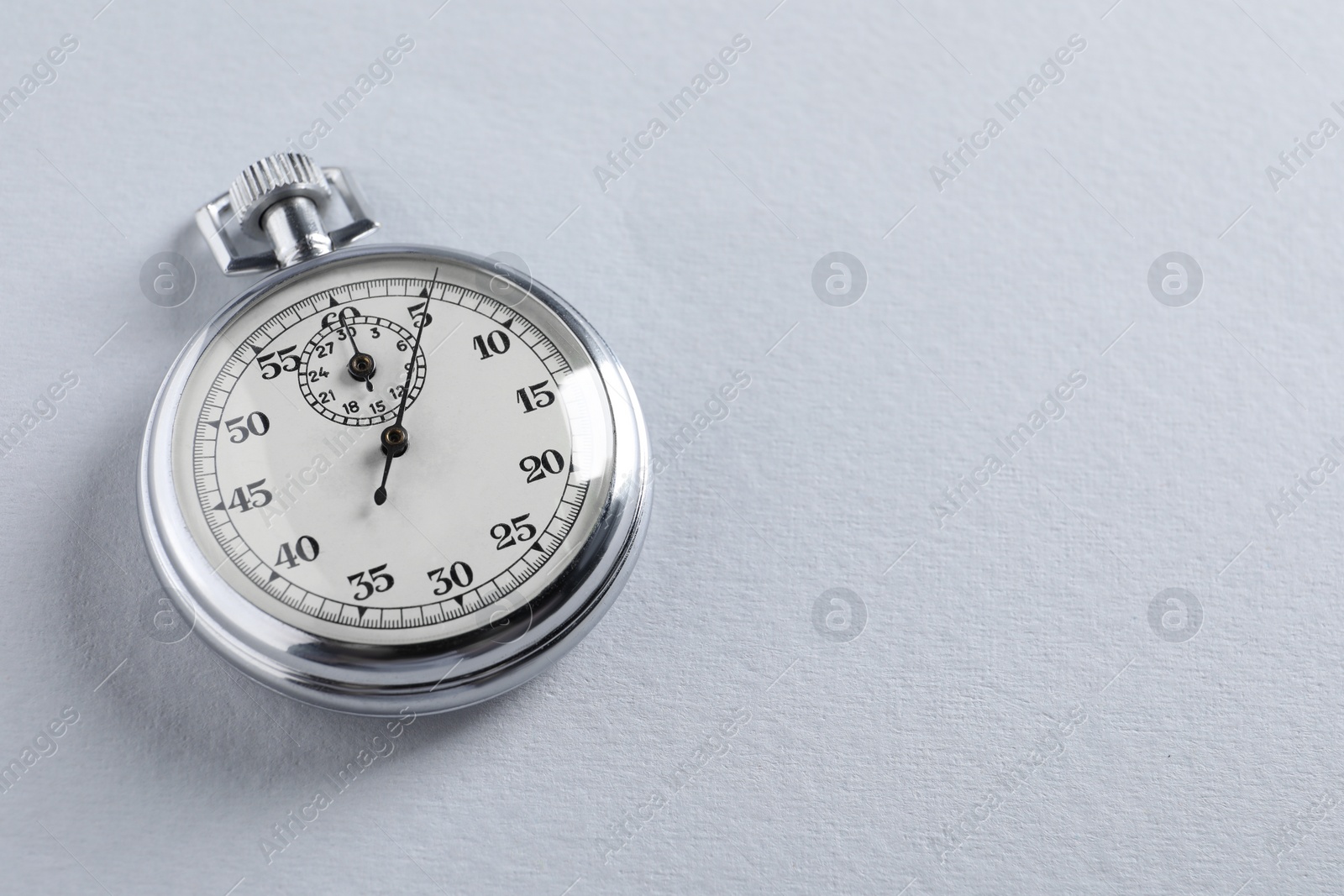 Photo of Vintage timer on light grey background, space for text. Measuring tool