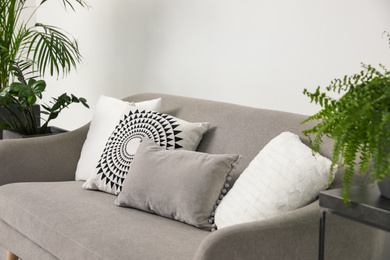 Soft pillows on grey sofa in living room